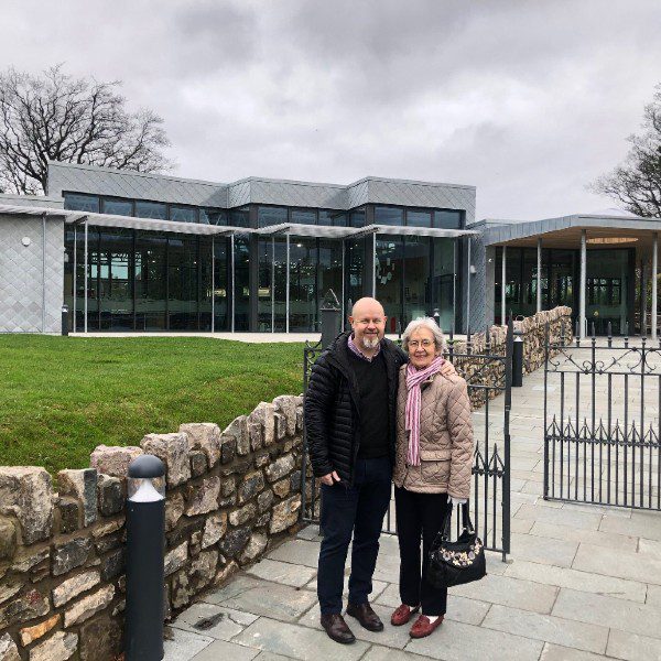 Featured image showing co-founder Enid Kitchin with son and current owner Pete Kitchin outside Enid's former school